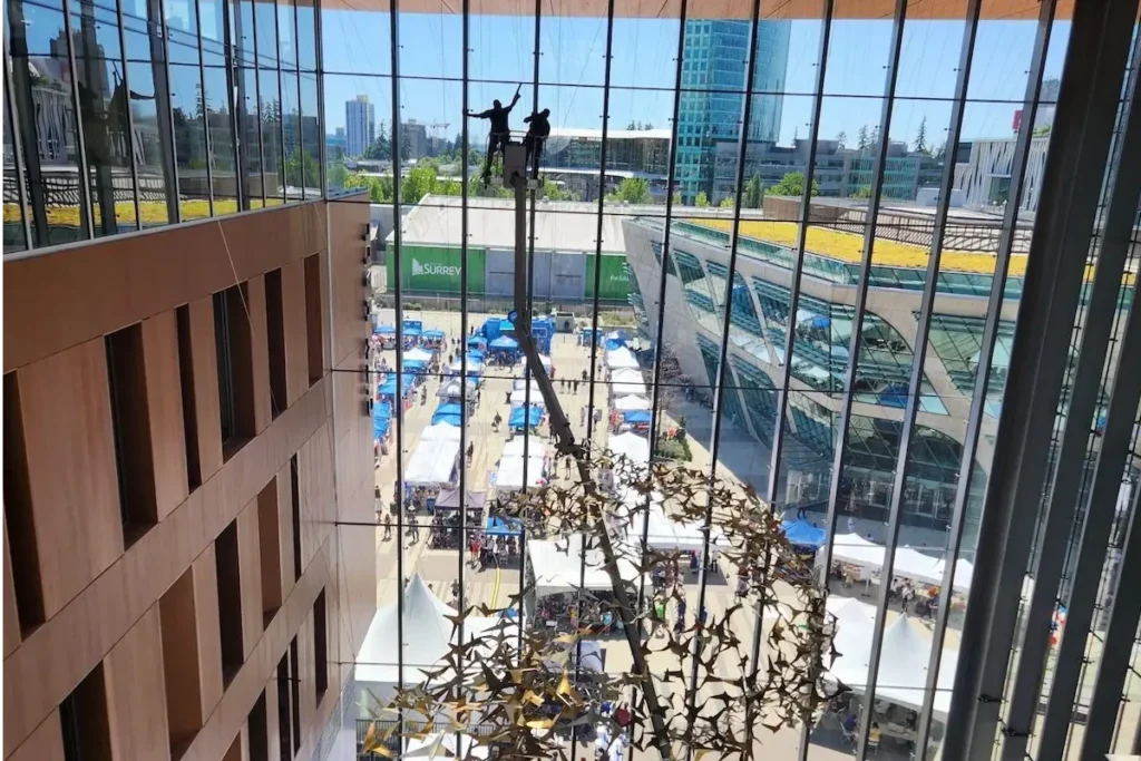 technicians cleaning windows inside from a boomlet