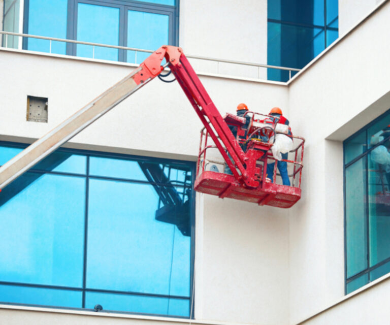 Painting a commercial low rise from boom lift