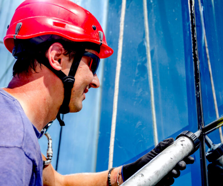 Technician performing caulking in commercial facility