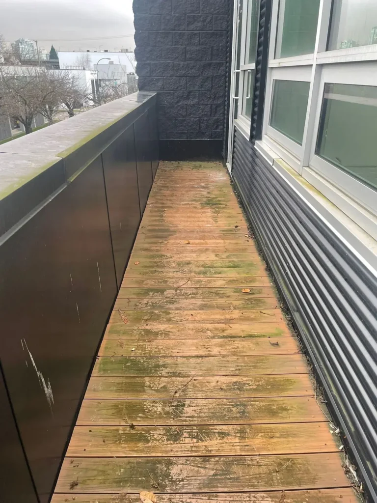 Pressure washing office balcony before