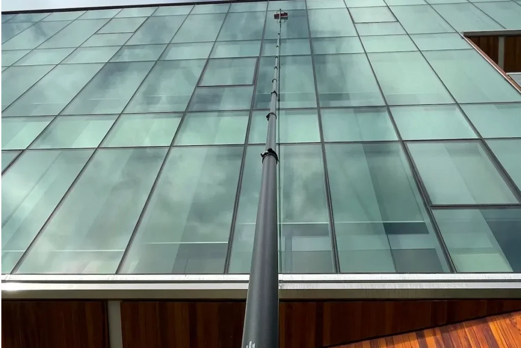 Cleaning windows with tucker pole